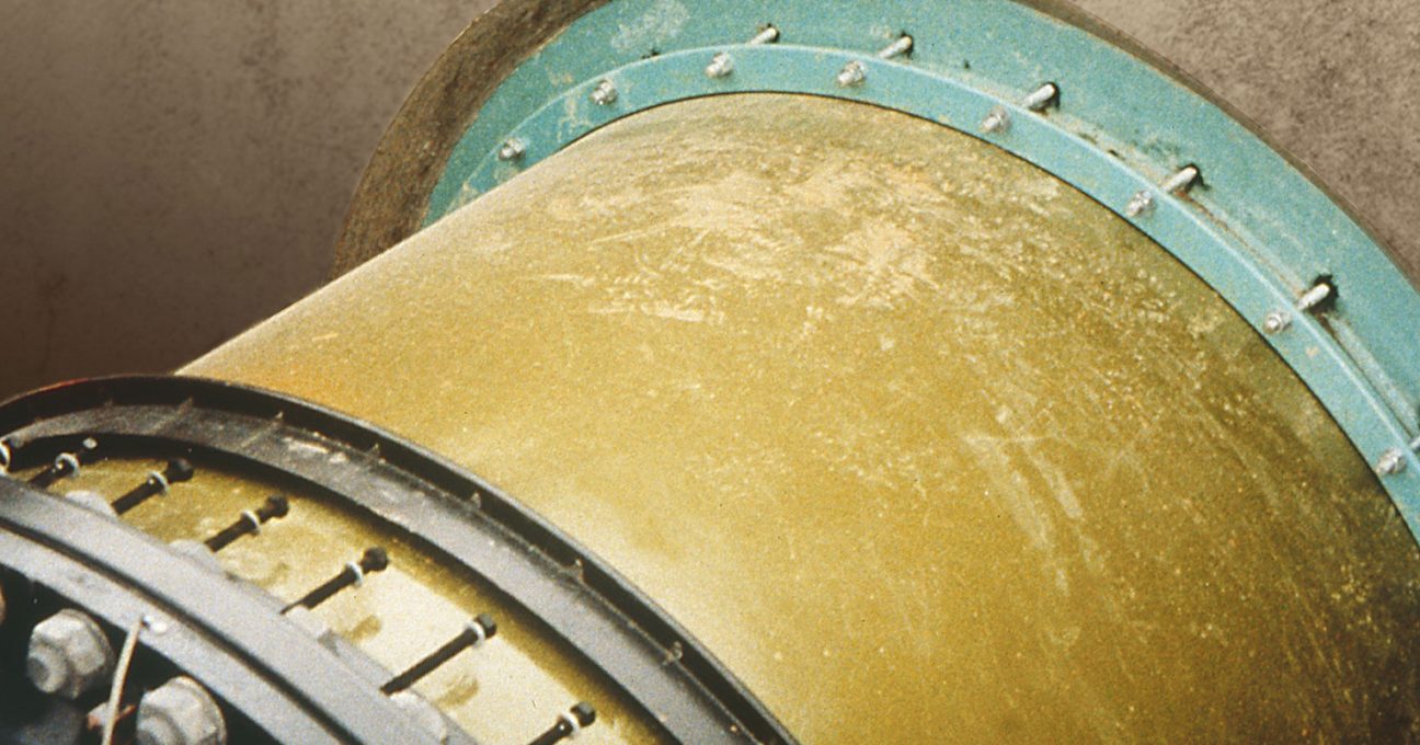 Close-up of a large industrial pipe with bolted metal flanges