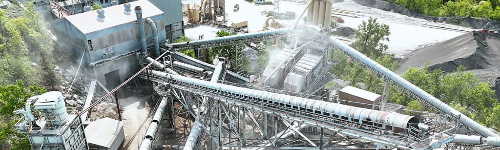 Aerial view of an industrial stone processing plant with conveyor belts and machinery