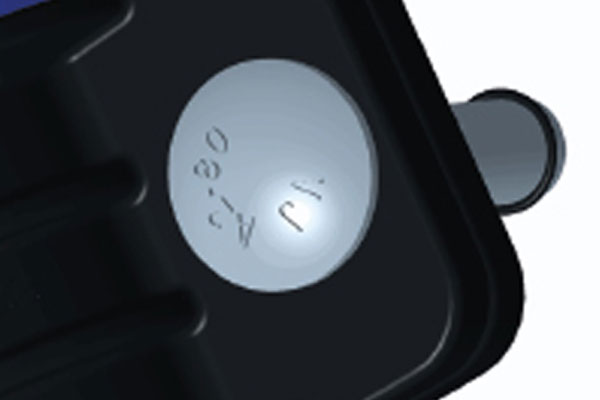 Close-up of a black component featuring a circular metal disc stamped with A.80 and a protruding pin