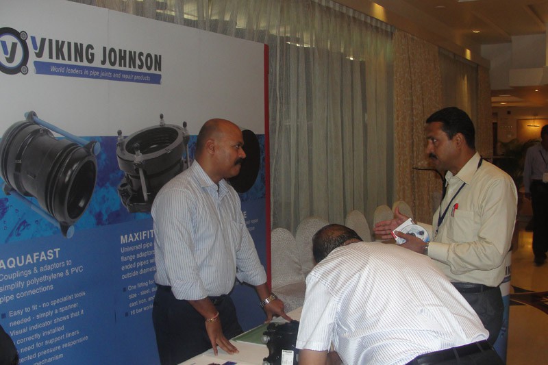 Two men conversing at a Viking Johnson trade exhibition stand