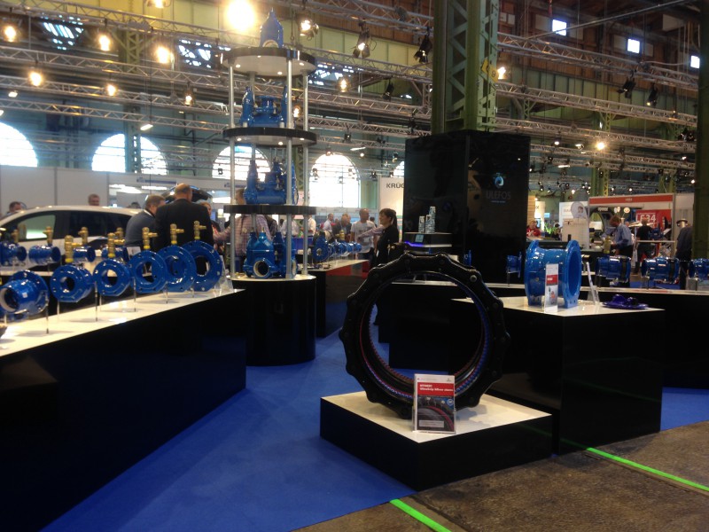 Exhibition stand displaying blue industrial valves, pipe fittings and pipe couplings