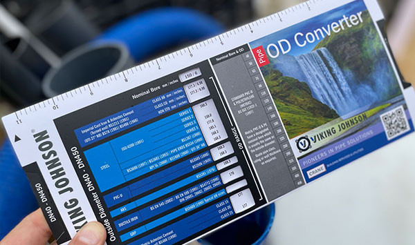 Hand holding a Viking Johnson Pipe OD Converter slide chart tool