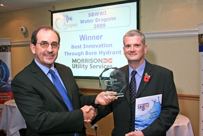 Two men shaking hands presenting the SBWWI Water Dragons 2009 Best Innovation award to Morrison Utility Services