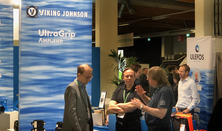 People conversing at a Viking Johnson trade show exhibition stand