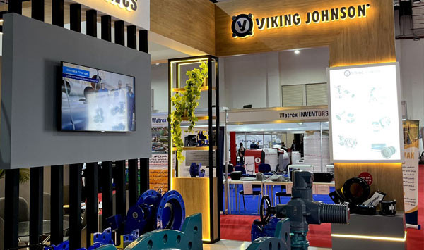 Viking Johnson exhibition stand displaying industrial pipe couplings, valves, and display screens