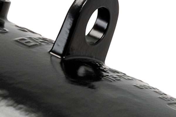 Close-up of a black metal mounting eyelet on a glossy cylindrical object