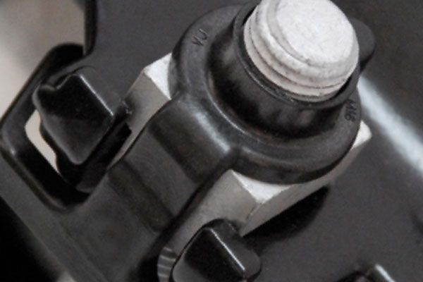Threaded bolt protruding through a black collar and square nut assembly