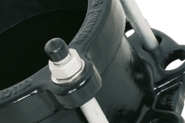 Close-up of a Viking Johnson pipe coupling showing a threaded bolt with a nut and protective black cap