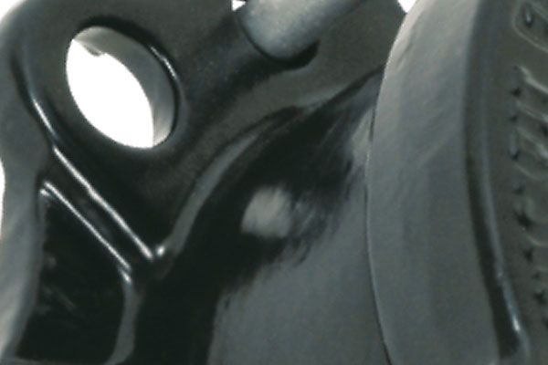 Close-up of a black metal component with a pin inserted into a mounting hole