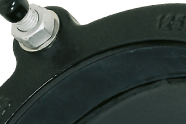 Close-up detail of a bolt with a nut and cap attached to a black flange assembly