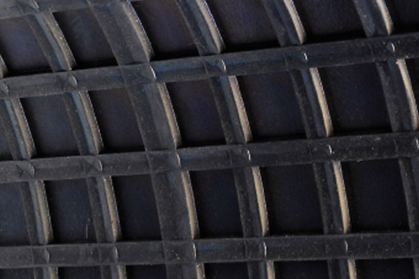 Close-up of a dark plastic grid texture