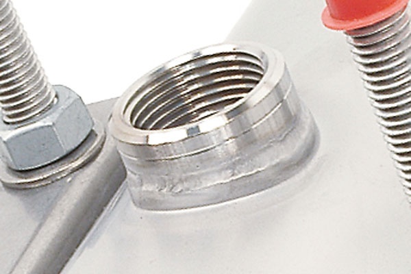 Close-up of a welded female threaded port on a metal component