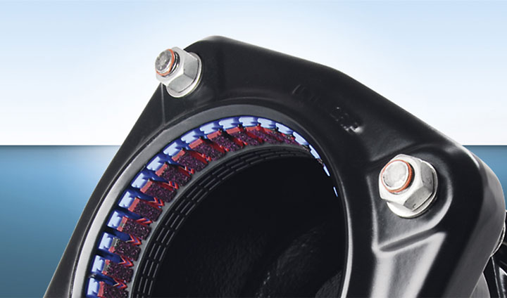 Detailed view of a black pipe restraint coupling with internal gripping teeth and flange bolts