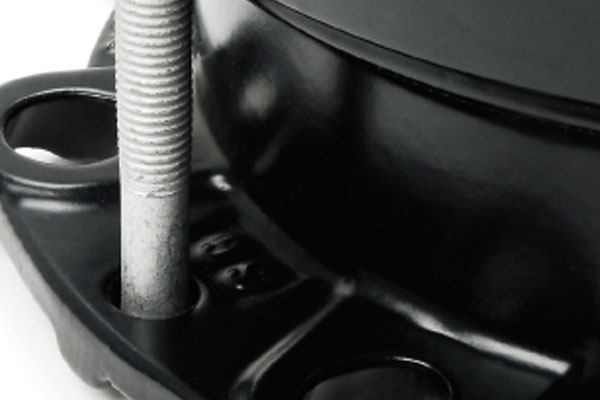 Threaded metal stud protruding through a mounting hole on a black metal base