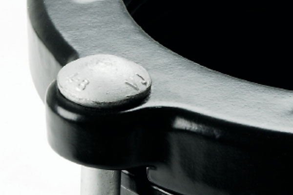 Close-up of a silver bolt securing a black metal pipe flange coupling