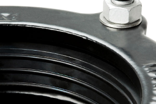 Black metal top mount with a silver hex nut, washer and ribbed rubber boot