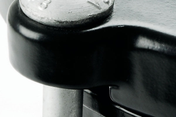 Close-up of a metal bolt secured through a black metal bracket