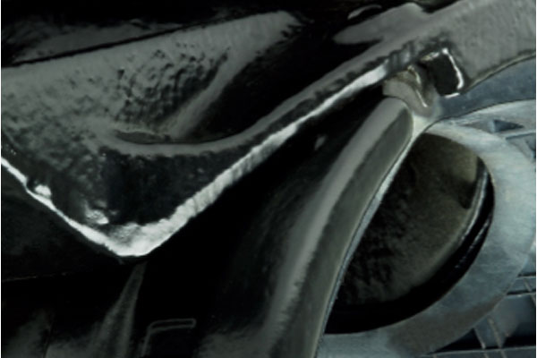 Close-up detail of glossy black painted metal components