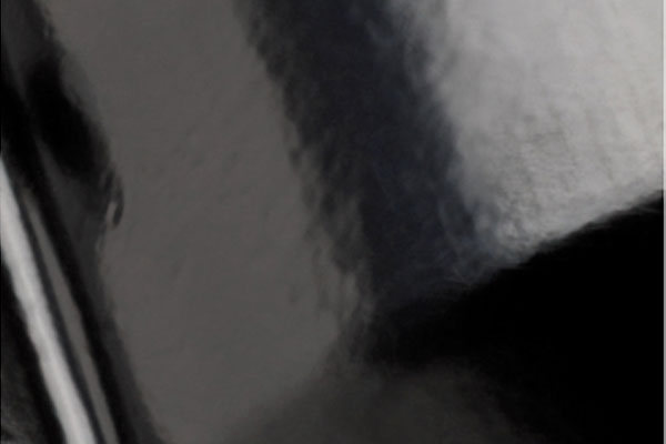 Close-up of a glossy black reflective surface