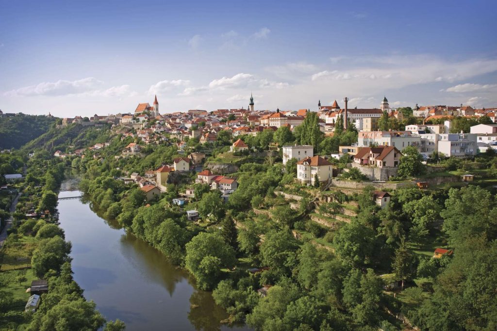 Panoramic view of Znojmo, Czechia, with historic red-roofed buildings on a hillside overlooking the Dyje River